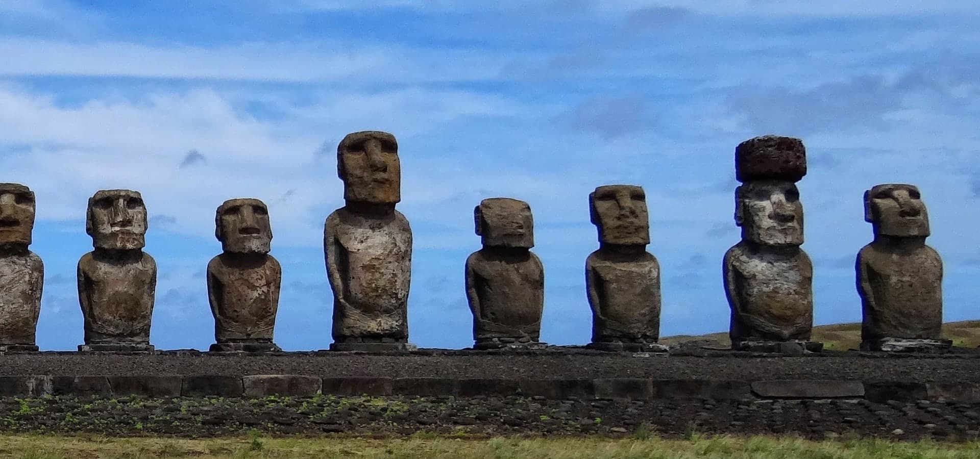 Dramatic clouds over mountain summits and open highlands.